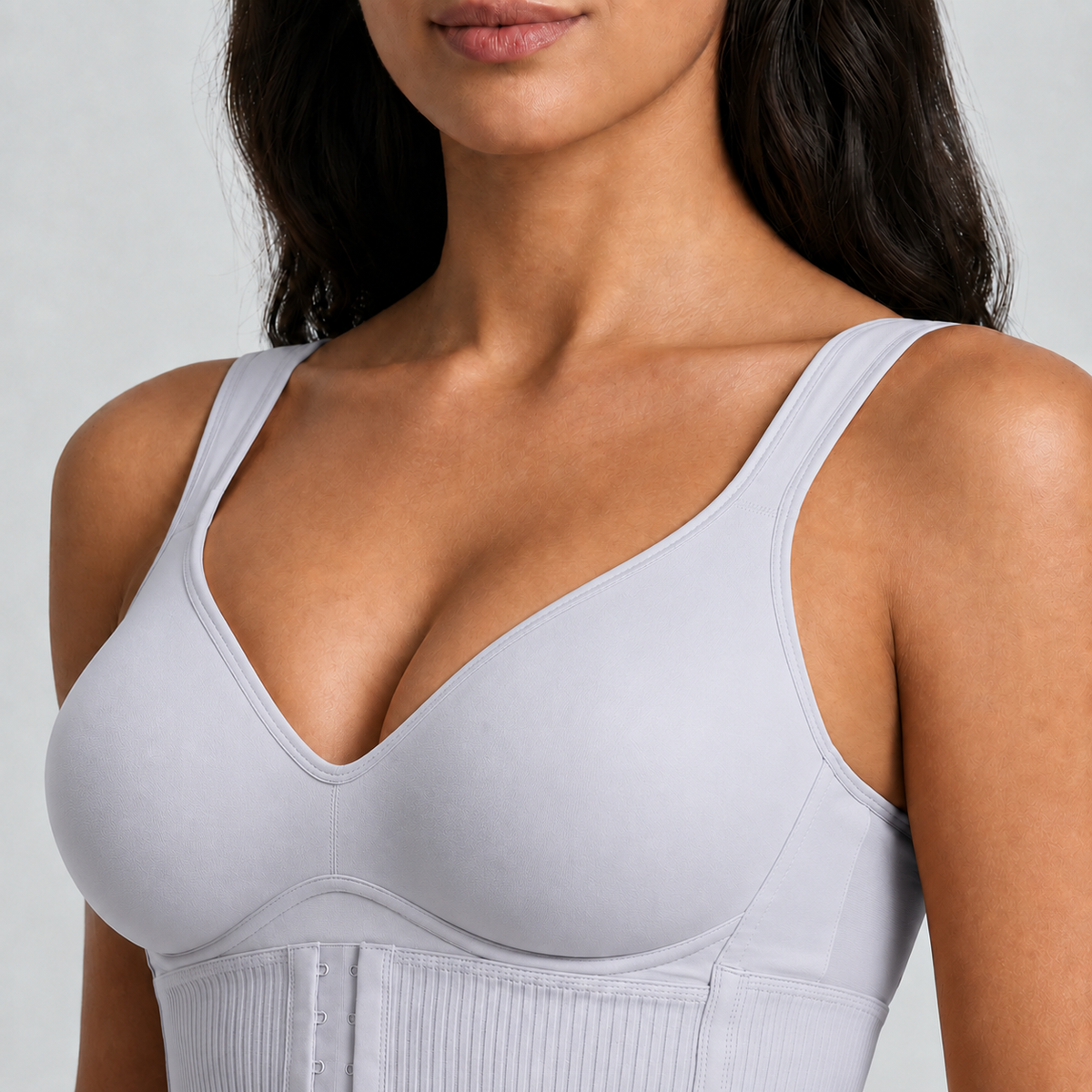 Close-up of the light grey Sollevia bra: seamless moulded cup and the three-position front closure